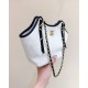 Chanel Maxi shopping bag, Braided raffia, calfskin & gold-tone