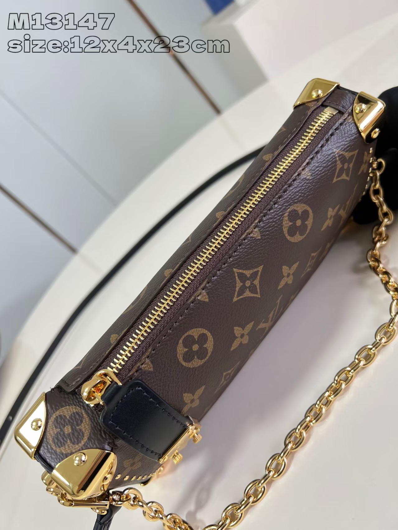 Louis Vuitton Slim Trunk handbag in classic monogram canvas with gold-tone hardware